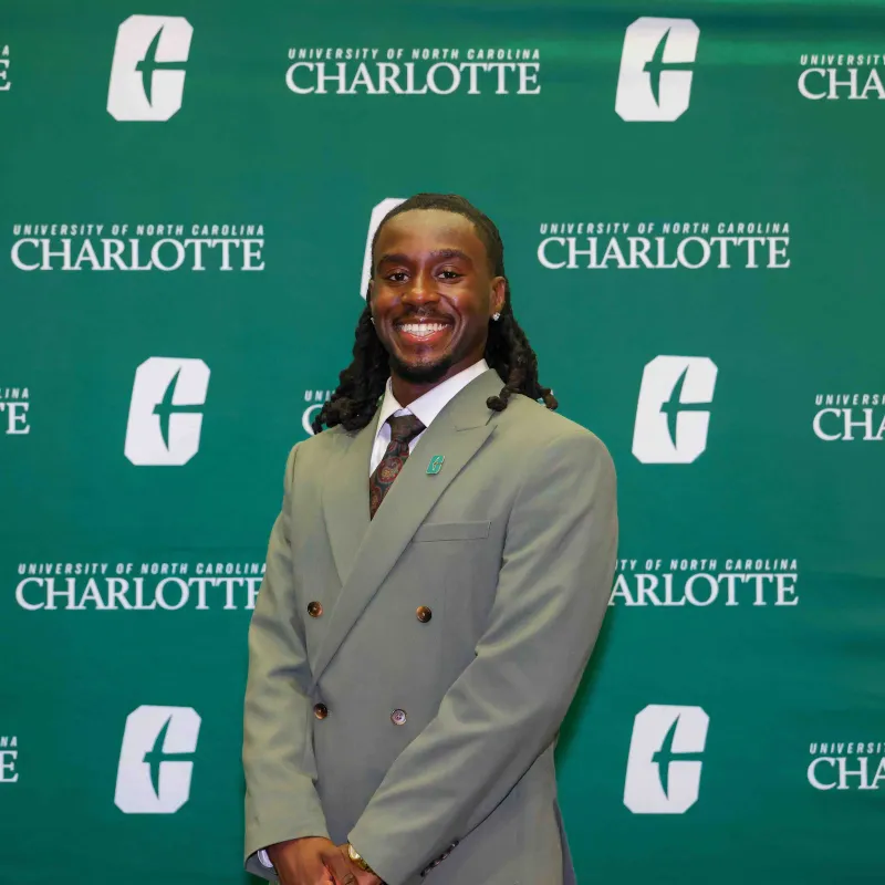 Patrick Bonna smiling with a UNC Charlotte backdrop