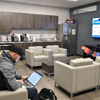 Students working in comfy chairs in the Veterans Student Lounge